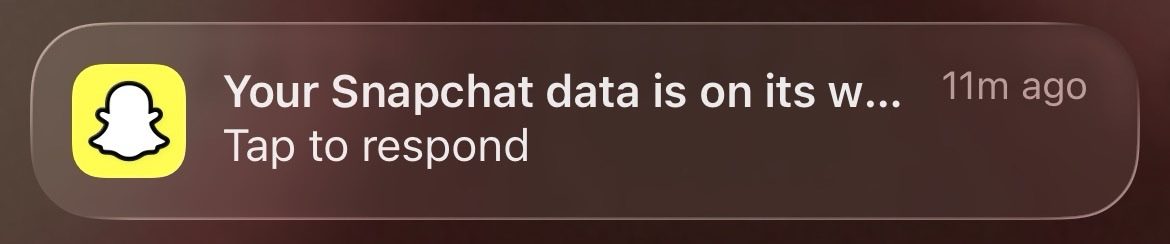 A push notification from the Snapchat app reading 'Your Snapchat data is on its way', received shortly after submitting the request.